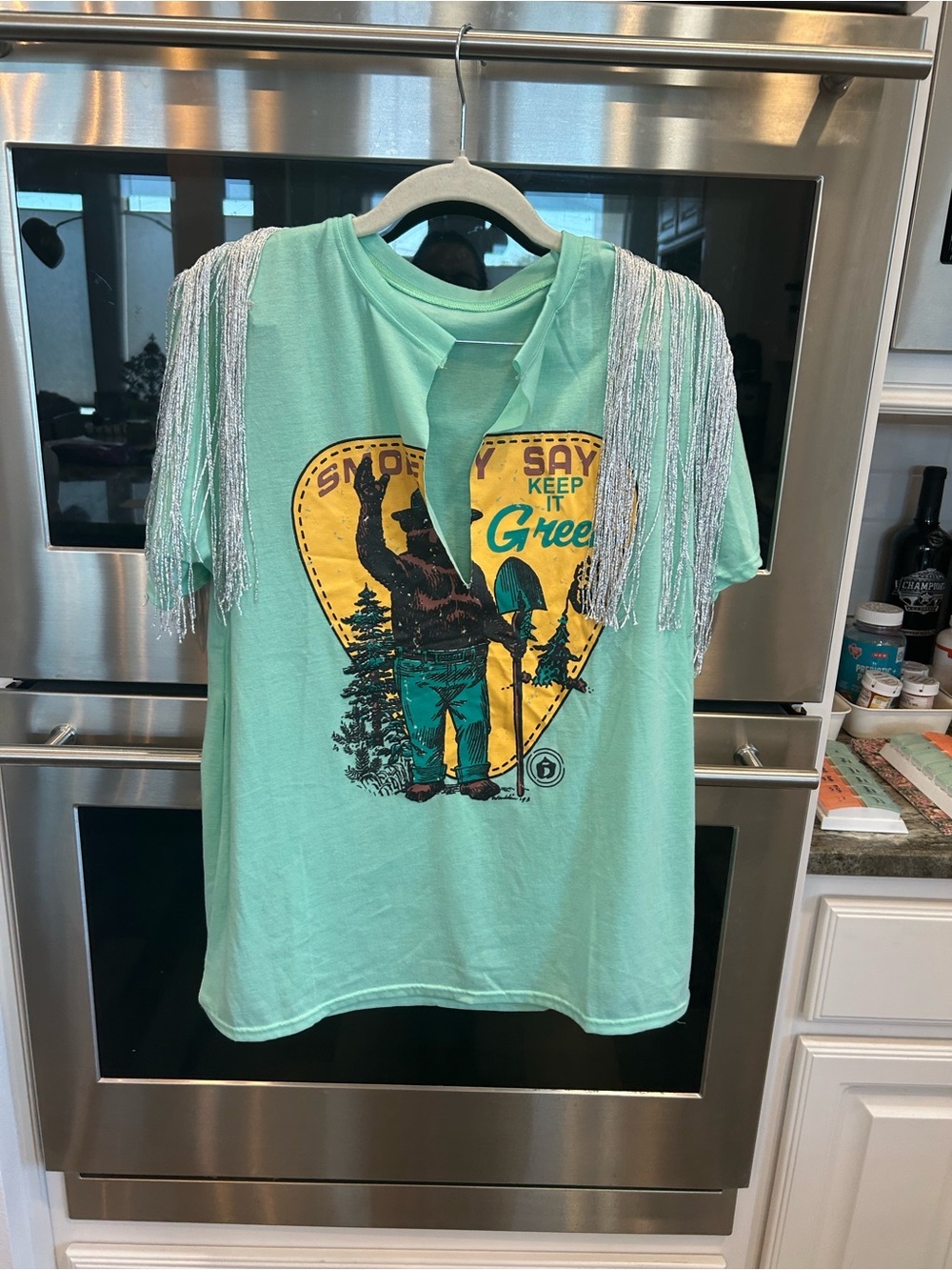 Swankaposh Smokey the bear tee with Silver Fringe Shoulder Detail size L